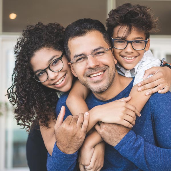 smiling family of three