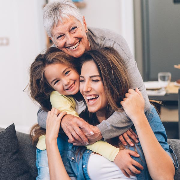 smiling family of three