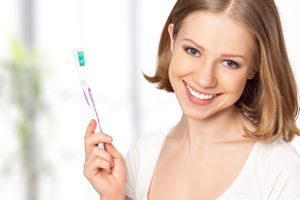 Beautiful woman holding toothbrush