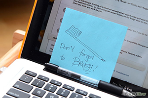 Laptop with pen and sticky note