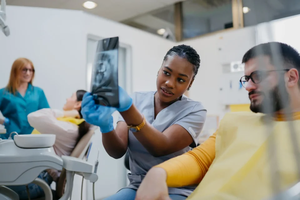 Dentist reviewing X-ray with patient during emergency dental consultation in Arlington Heights, IL