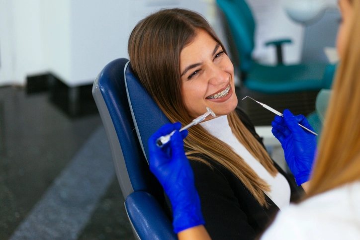 Young woman smiling confidently after Invisalign treatment, showing teeth in Arlington Heights, IL