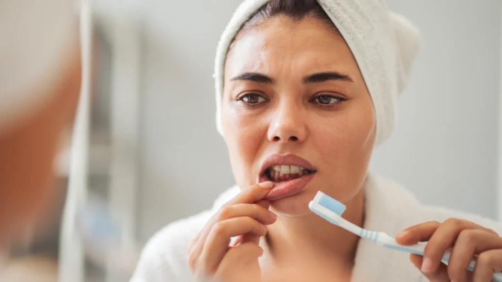 Lady brushing teeth and noticing gum issues in Arlington Heights, IL